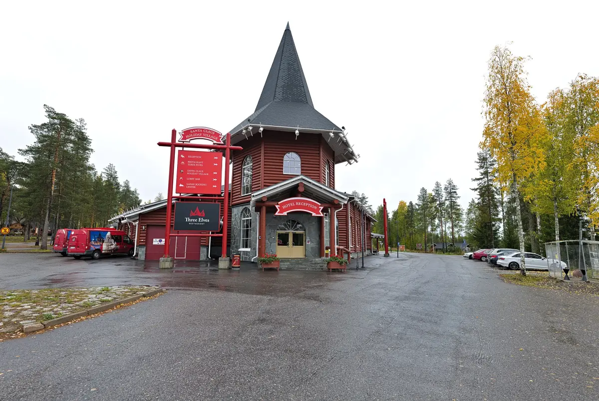 Red wooden Christmas House with pointed tower roof at Santa Claus Village in autumn