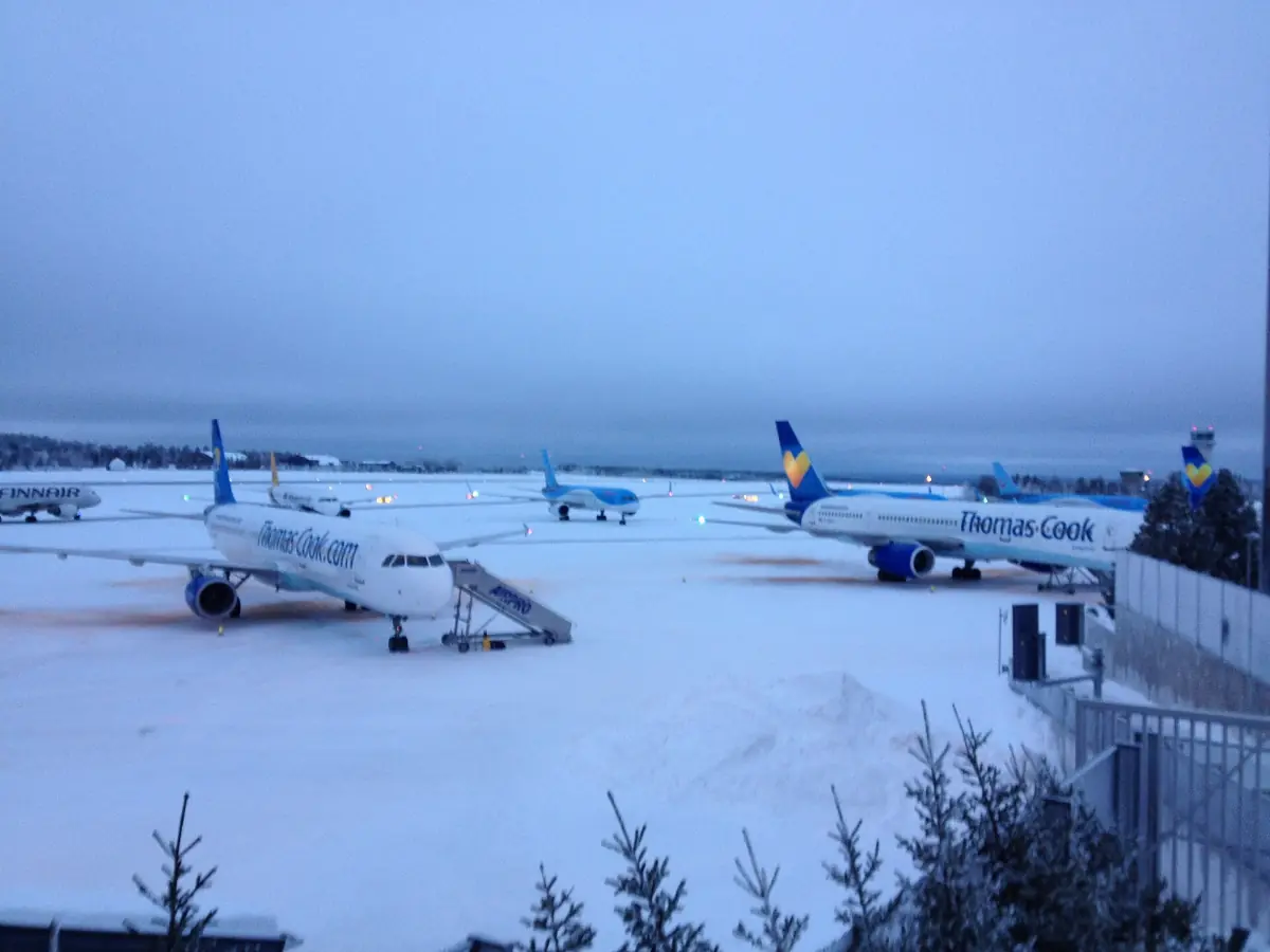 Passenger aircraft parked in snow on the apron at Rovaniemi Airport