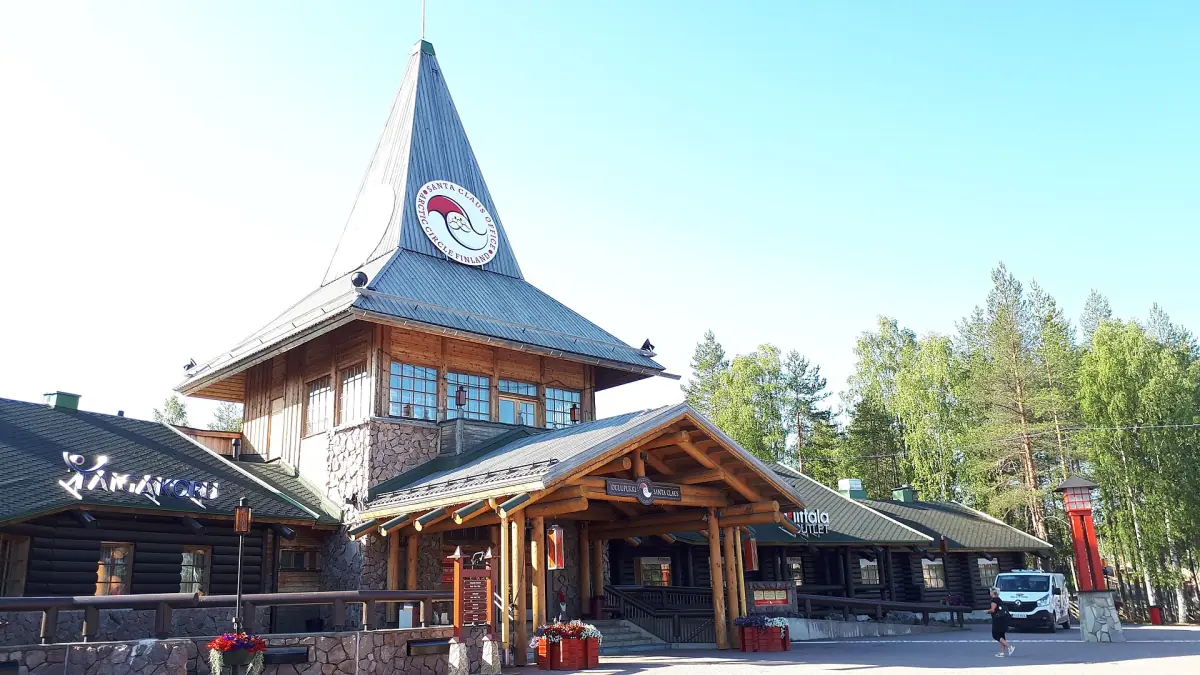 Santa Claus Main Post Office building with pointed tower roof under blue sky in Rovaniemi