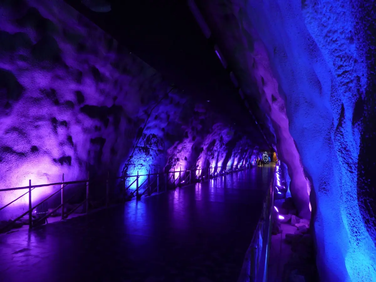 Underground tunnel lit in purple and blue light at SantaPark near Rovaniemi