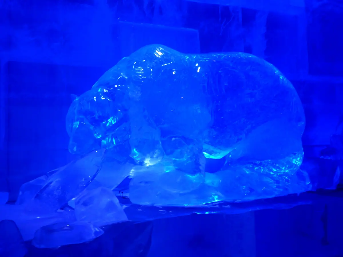 Blue-lit ice sculpture of an animal at SantaPark in Rovaniemi